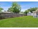 Large, fenced backyard with lush green grass and mature trees at 417 El Salvador Dr, Lakeland, FL 33809