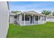 A view of the back of this home showing the air conditioning unit and rear porch at 417 El Salvador Dr, Lakeland, FL 33809