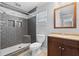 Stylish bathroom featuring tiled shower with recessed shelving, modern toilet, and vanity at 417 El Salvador Dr, Lakeland, FL 33809