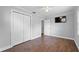 Bedroom with wood floors, closet, and mounted TV at 417 El Salvador Dr, Lakeland, FL 33809