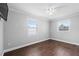 Cozy bedroom features two windows and hardwood floors at 417 El Salvador Dr, Lakeland, FL 33809