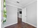 Bright bedroom with hardwood floors, neutral walls, and doorway to the hall at 417 El Salvador Dr, Lakeland, FL 33809