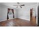 Comfortable bedroom with stylish fan, wood-look tile floor, window and closet at 417 El Salvador Dr, Lakeland, FL 33809
