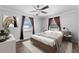 Bright bedroom features hardwood floors, ceiling fan, and comfortable neutral decor at 417 El Salvador Dr, Lakeland, FL 33809