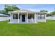A well maintained yard and a home that welcomes you with a rocking chair on the front porch at 417 El Salvador Dr, Lakeland, FL 33809