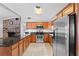 Spacious kitchen with stainless steel appliances, granite counters, and view to brick fireplace at 417 El Salvador Dr, Lakeland, FL 33809