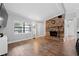 Inviting living room with hardwood floors, a brick fireplace, and abundant natural light at 417 El Salvador Dr, Lakeland, FL 33809