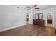 Main bedroom with wood-look tile, ceiling fan, dresser, and en suite bathroom access at 417 El Salvador Dr, Lakeland, FL 33809
