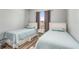 Bedroom with two twin beds, side table, and window at 436 Lady Diana Dr, Davenport, FL 33837
