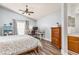 Relaxing bedroom with vaulted ceiling, wood floors, desk area, and en suite bathroom with wood cabinets at 436 Lady Diana Dr, Davenport, FL 33837