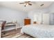Cozy bedroom featuring light blue walls, wood floors, and a desk area with a wood dresser at 436 Lady Diana Dr, Davenport, FL 33837