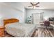Cozy bedroom featuring wood floors, a ceiling fan, window and a desk area at 436 Lady Diana Dr, Davenport, FL 33837