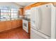 Bright kitchen featuring tile floors, wooden cabinets, granite countertops and white appliances at 436 Lady Diana Dr, Davenport, FL 33837