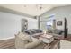 Bright living room featuring vaulted ceilings, wood floors, and comfortable seating around a coffee table at 436 Lady Diana Dr, Davenport, FL 33837