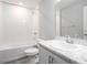 Clean bathroom with white fixtures, marble countertop, and shower-tub combination at 4486 Rapallo Ave, Winter Haven, FL 33884