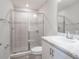 Bright bathroom features a shower with gray tile surround, glass door, and white marble vanity at 4486 Rapallo Ave, Winter Haven, FL 33884