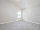 Bright and airy bedroom with neutral walls and plush carpet, featuring a single window at 4486 Rapallo Ave, Winter Haven, FL 33884
