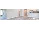 Spacious living area with luxury vinyl plank flooring adjacent to kitchen and access to lanai at 4486 Rapallo Ave, Winter Haven, FL 33884
