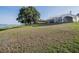 Large backyard featuring a mature tree and a view of the home with a screened patio and lake access at 4808 Juliana Reserve Dr, Auburndale, FL 33823