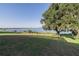 Lush backyard with mature trees and a glimpse of the lake, offering a peaceful and private outdoor space at 4808 Juliana Reserve Dr, Auburndale, FL 33823