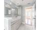 Bathroom featuring dual sinks, granite countertops, tile flooring, and modern fixtures at 4808 Juliana Reserve Dr, Auburndale, FL 33823