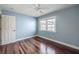 Bright bedroom with hardwood flooring, natural light, ceiling fan, and neutral walls at 4808 Juliana Reserve Dr, Auburndale, FL 33823