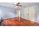 Bright bedroom with hardwood floors, neutral walls, and closet space at 4808 Juliana Reserve Dr, Auburndale, FL 33823