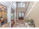Welcoming foyer with double front doors and a staircase leading upstairs is brightly lit from a decorative window at 4808 Juliana Reserve Dr, Auburndale, FL 33823