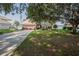 Beautiful two-story home with lush landscaping, a large driveway, and a peek of the tranquil lake nearby at 4808 Juliana Reserve Dr, Auburndale, FL 33823