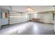 Spacious garage featuring a roll up door, storage cabinets, and ample room for vehicles or storage at 4808 Juliana Reserve Dr, Auburndale, FL 33823