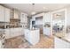 Well-equipped kitchen with custom cabinetry, an island, stainless steel appliances, and stone flooring at 4808 Juliana Reserve Dr, Auburndale, FL 33823