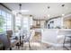 Bright kitchen with white cabinetry, stainless steel appliances, travertine flooring, and a breakfast nook with water views at 4808 Juliana Reserve Dr, Auburndale, FL 33823