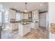Spacious kitchen featuring white cabinetry, granite countertops, a center island, and modern appliances at 4808 Juliana Reserve Dr, Auburndale, FL 33823