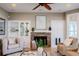 Comfortable living room featuring a stone fireplace and built-in cabinets, offering a cozy retreat at 4808 Juliana Reserve Dr, Auburndale, FL 33823