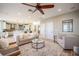 Spacious living room flowing into the kitchen, perfect for entertaining, featuring tile flooring and neutral decor at 4808 Juliana Reserve Dr, Auburndale, FL 33823