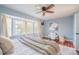 Cozy main bedroom featuring a bay window, ceiling fan, and hardwood floors, exuding comfort and style at 4808 Juliana Reserve Dr, Auburndale, FL 33823