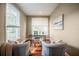 Cozy home office with hardwood floors, large windows, and comfortable seating at 4808 Juliana Reserve Dr, Auburndale, FL 33823