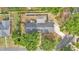 A birds eye view of the home shows mature trees, landscaping, and a long driveway at 4825 Foxrun, Lakeland, FL 33813