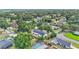 An aerial view of neighborhood homes shows mature trees and lush landscaping at 4825 Foxrun, Lakeland, FL 33813