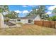 This home features a fenced in backyard, planting beds, and a sunroom at 4825 Foxrun, Lakeland, FL 33813