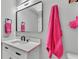Bathroom sink and countertop with modern fixtures, mirror, and pink towel at 4825 Foxrun, Lakeland, FL 33813