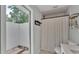 Bright bathroom featuring a private outdoor shower area and neutral toned tile and walls at 4825 Foxrun, Lakeland, FL 33813