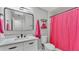 Bathroom with modern lighting, bright sink, and shower with a pink curtain at 4825 Foxrun, Lakeland, FL 33813