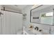 Clean bathroom with white tile and a shower with black hardware and a mirror at 4825 Foxrun, Lakeland, FL 33813