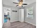 Bedroom featuring a ceiling fan, wood floors, built in storage, and views of the living room at 4825 Foxrun, Lakeland, FL 33813