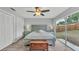 Bright bedroom with a large window, ceiling fan, and sliding glass door at 4825 Foxrun, Lakeland, FL 33813