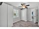 Bedroom featuring a ceiling fan, wood floors, built in storage, and a window at 4825 Foxrun, Lakeland, FL 33813