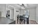 Well-lit dining room features a modern chandelier and black table set near the hallway at 4825 Foxrun, Lakeland, FL 33813