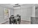 Light-filled dining room features a modern chandelier and table set with gray walls at 4825 Foxrun, Lakeland, FL 33813