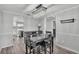 A dining room with a black table set, crystal chandelier, and elegant gray walls at 4825 Foxrun, Lakeland, FL 33813
